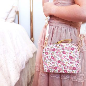 Crossbody carry case in pink rose garden floral.