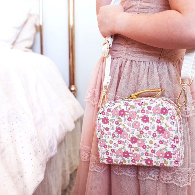 Crossbody carry case in pink rose garden floral.